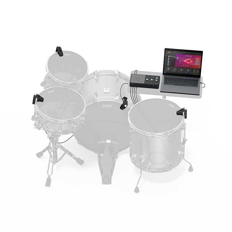 A photo of the sensors attached to a standard drum set, with the portal and a laptop on the stand next to the drums. The drums are greyed out, and what comes in the box (sensors, portal, and cables are in color.)